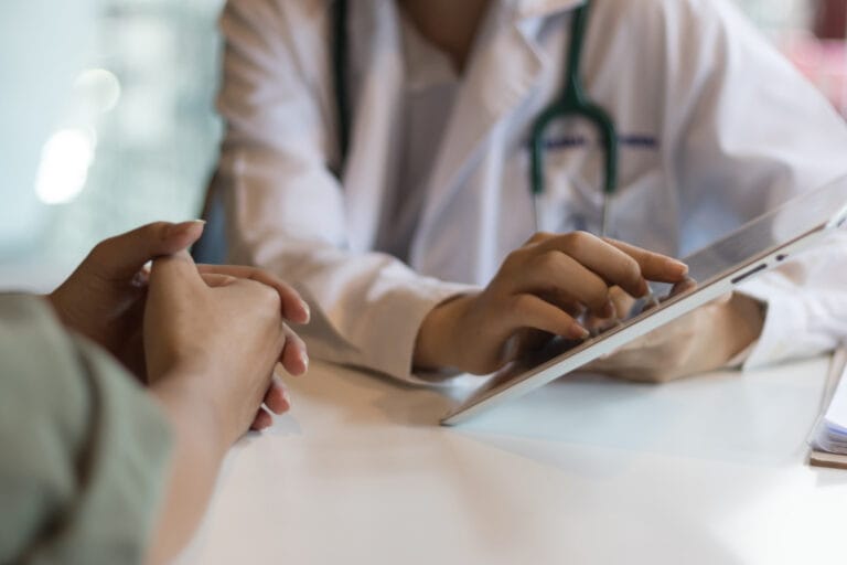 Shot of a doctor showing a patient some information on a digital tablet