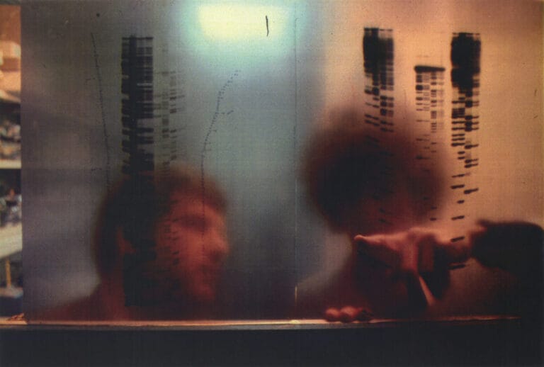 picture of a man looking in the reflection with sequencing on the wall