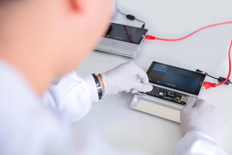 Picture of a scientist using his hands to insert flow cell.