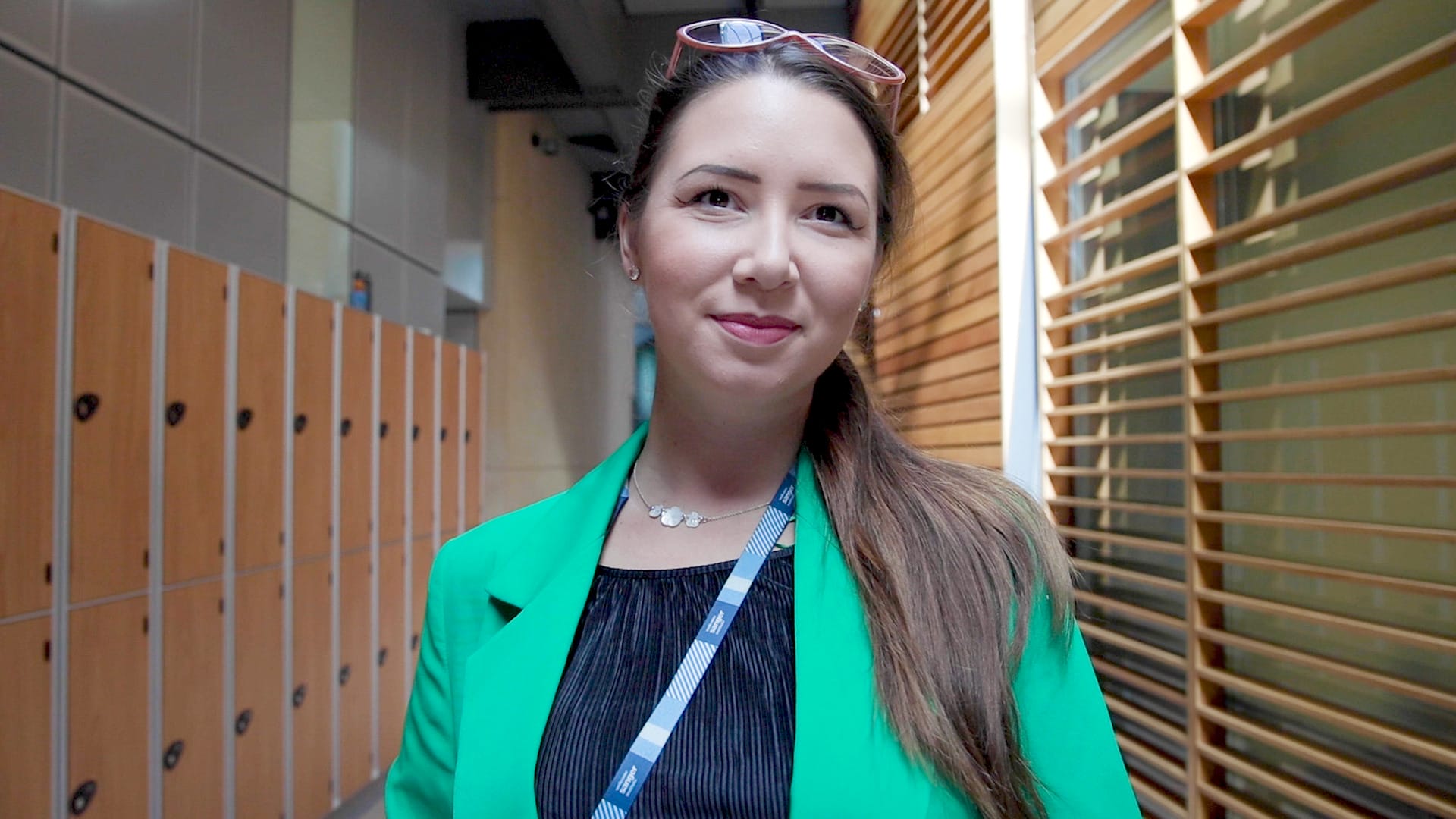 Picture of Georgia smiling, standing in a corridor.
