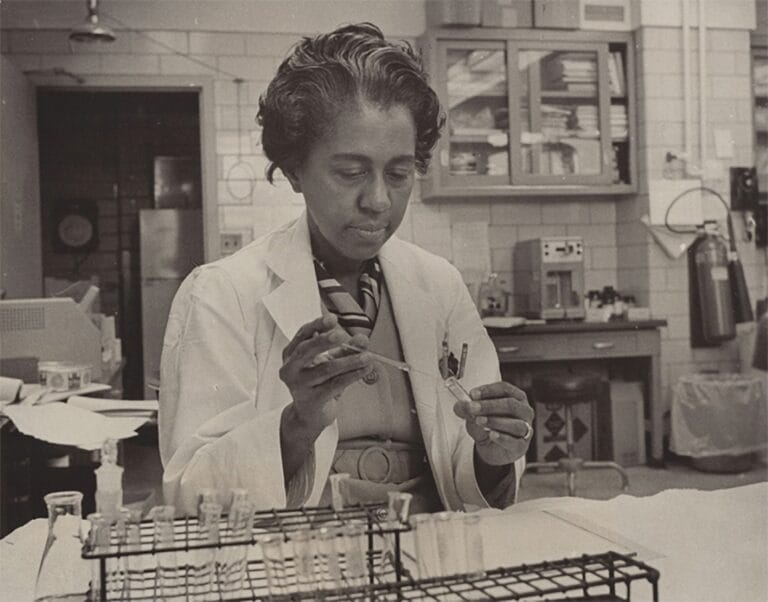 black and white photo of Marie Maynard Daly conducting an experiment in a lab setting