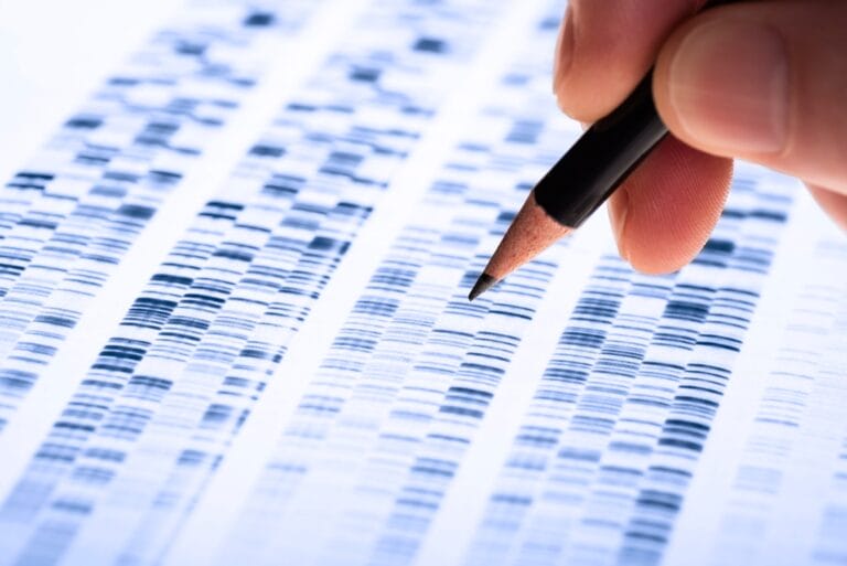 DNA profiling with someone holding a pencil above it