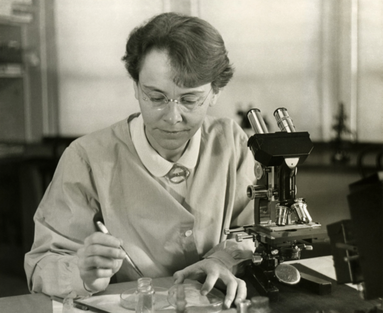 black and white photo of Barbara McClintock conducting a science experiment