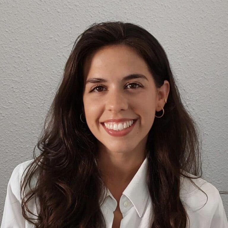 A headshot of Ana Paredes smiling at the camera.