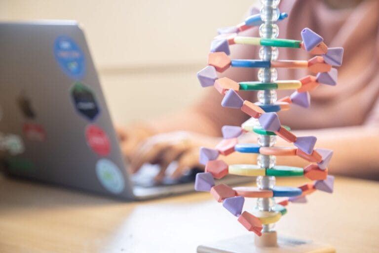 DNA model with computer in background